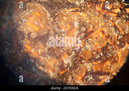 Warme Speisen draußen. Armenische Küche. Boily Fleisch in einer heißen Pfanne. Köstliche Suppe mit Karotten und Kalb. Stockfoto