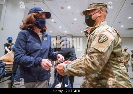 New York City, Usa. 22nd. November 2021. Die New Yorker Gouverneurin Kathy Hochul unterstützt Soldaten mit der New Yorker Nationalgarde und Luftfahrtschirme, die dem Empire Shield der Joint Task Force zugewiesen sind, und verteilt Thanksgiving-Truthähne für bedürftige Familien im Jacob Javits Convention Center, 22. November 2021 in New York City. Quelle: Darren McGee/New York National Guard/Alamy Live News Stockfoto