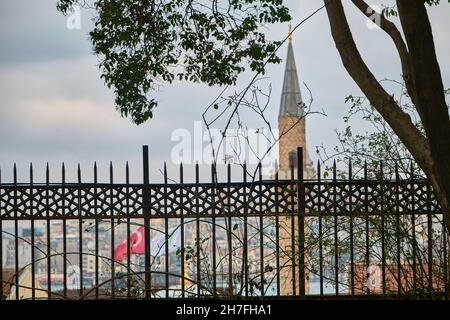 Minarett einer Moschee Blick vom Gulhane Park istanbul mit Antiker Galata Tower Hintergrund während des bewölkten und regnerischen Tages in istanbul im März Stockfoto