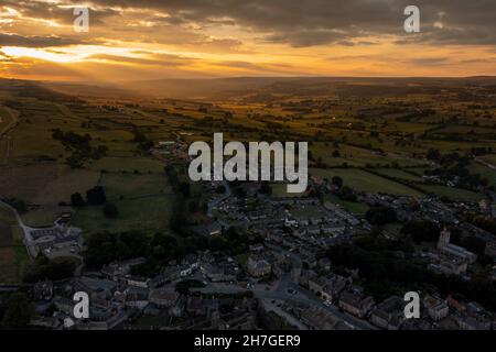 Luftaufnahme bei Sonnenuntergang im schönen Dorf Middleham, Leyburn in North Yorkshire in Großbritannien, zeigt den Sonnenuntergang hinter dem britischen Dorf Stockfoto