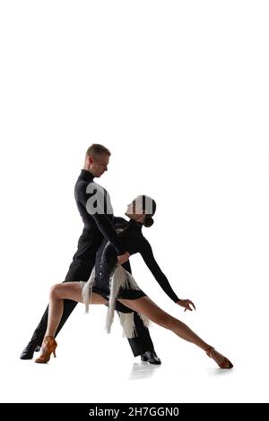 Dynamisches Porträt von jungen anmutigen Tänzern, flexible Mann und Frau tanzen Ballsaal Tanz isoliert auf weißem Studio Hintergrund. Stockfoto