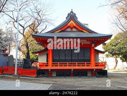 Der Hanazono-Schrein mit leuchtend farbigen Gebäuden und Torientoren in Shinjuku, Tokio, Japan. Es ist eines der wichtigsten Inari-Schreine in Japan. Stockfoto