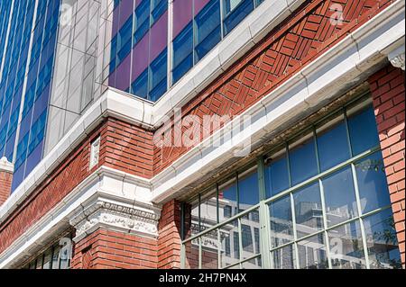 Ein Band aus altem Mauerwerk aus dem alten Troy Laundry-Gebäude verläuft um das Erdgeschoss eines neuen Bürogebäudes in Seattle. Stockfoto