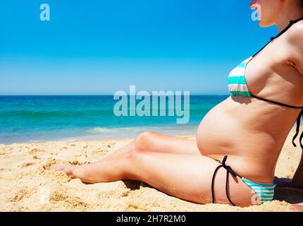 Schwanger Frau auf Sand am Strand Bauch Nahaufnahme Stockfoto