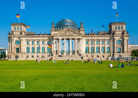 Herrlicher Blick auf die Westseite des berühmten Reichstagsgebäudes mit Rasen in Berlin, in dem sich der Bundestag, das Unterhaus des... Stockfoto