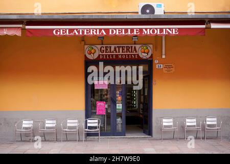 Gelateria ohne Kunden in Bologna während der Corona-Pandemie. Leere Tische und Stühle auf dem Bürgersteig davor. Stockfoto