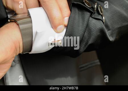 Silberner Manschettenknauf am Bündchen eines eleganten Herrenhemdes. Stockfoto