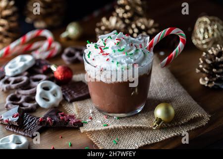 Nahaufnahme einer Tasse heißer Schokolade mit Peitschencreme und Streuseln auf der Oberseite. Stockfoto