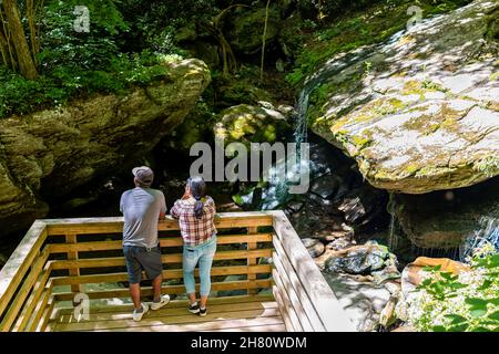 Seven Devils, USA - 4. Juni 2021: Otter Falls Trail mit Blick auf die Menschen am Aussichtspunkt für den berühmten Wasserfall in North Carolina während der Sommerreisezeit Stockfoto