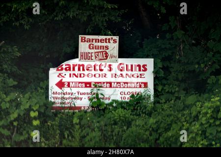 Hampton, USA - 23. Juni 2021: Tennessee Mountain Town mit Schild auf dem Highway auf der US-19e 19e Road für Barnett's Guns und Indoor-Schießstand Rabatt Stockfoto