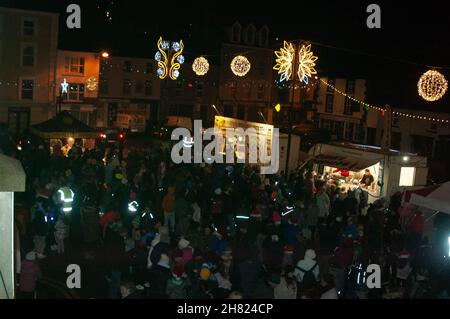 Macroom, Irland. 26th. November 2021. Freitag, 26. November Macroom, Co. Cork Irland; als die Festtage näher rückt, versammelten sich die Menschen von Macroom um die hundert, um die Weihnachtsbeleuchtung der Stadt zu sehen. Standbesitzer verkauften auch Pizzen und Studenten der McEgan College Secondary School in der Stadt verkauften Kuchen aus ihrem Mini-Geschäft. Kredit: Evan Doak/Alamy Live Nachrichten Stockfoto