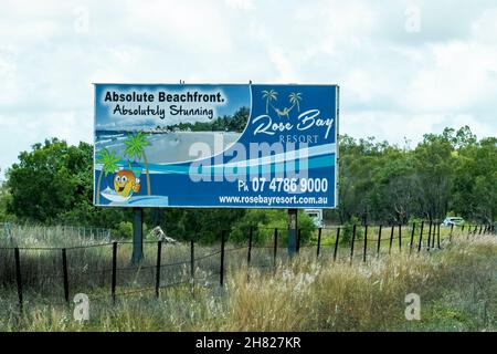 Bruce Highway Townsville nach Mackay, Queensland, Australien - 2021. November: Rose Bay Resort wirbt auf der Außenwerbung für absolute Breach Front Stockfoto