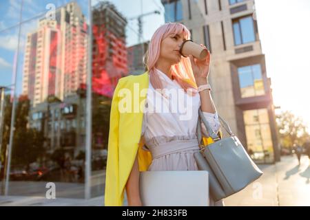 Junge Frau trinkt Kaffee auf der Straße Stockfoto