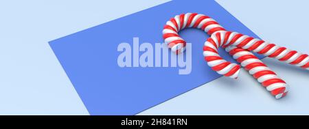 Zuckerstöcke auf einer leeren Karte, pastellblauer Hintergrund, Platz. Vorlage für frohe Weihnachten. Pfefferminzrot weiß gestreifte traditionelle Süßigkeiten für Kinder. 3D i Stockfoto