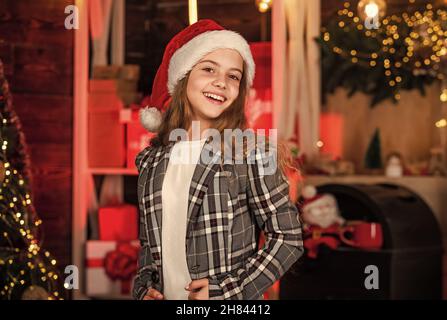 Schlagen Sie den Weihnachtsrausch. Kind in santa Hut. Geschenke und Geschenke für die nächste. Familienurlaub. santa Mädchen feiern Weihnachten. weihnachtskomposition Stockfoto