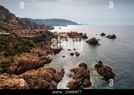Luftaufnahme einer steinernen Küste und türkisfarbenem Meerwasser, das von der Sonne beleuchtet wird. Stockfoto