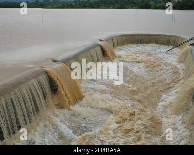 Braunes Wasser im Staudamm, das in den Überlauf überläuft, Hochwasser in der Regenzeit, Thailand Stockfoto