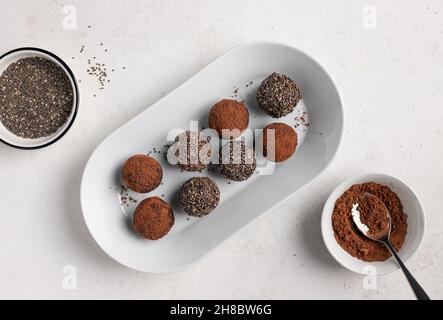 Energiekugeln aus Datteln, Nüssen, Chiasamen und Kakao Stockfoto