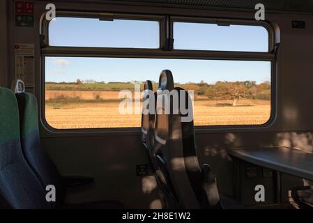 Devon, England, Großbritannien. 2021. Sitzplätze im Personenzug mit Aussicht, wenn der Zug die Landschaft von Devonshire entlang der Dartmoor-Linie passiert. Stockfoto