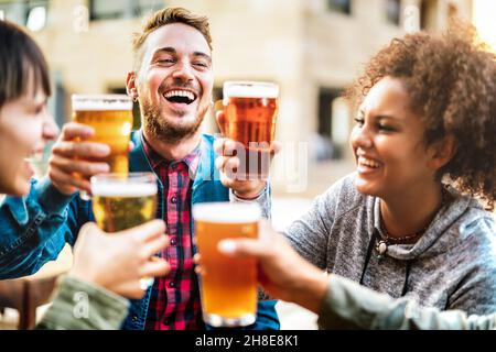 Multikulturelle glückliche Freunde trinken und rösten Bier in der Brauerei Bar Restaurant - Getränke Lifestyle-Konzept mit Männern und Frauen Spaß zusammen haben Stockfoto