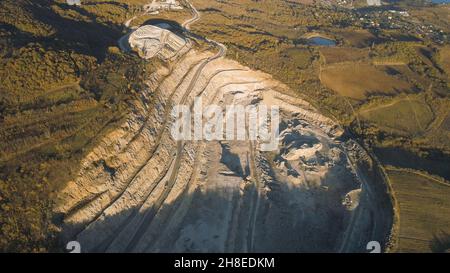 Panoramablick auf den Steinbruch. Aufnahme. Draufsicht auf malerischen Steinbruch auf Küstenberg in der Nähe von Dorf im Wald. Konzept des Bergbaus. Stockfoto