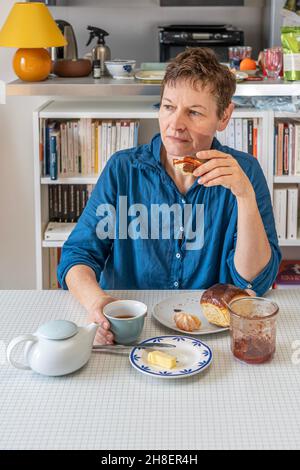 Paris, Frankreich - 11 27 2021: Eine Frau beim Frühstück zu Hause Stockfoto