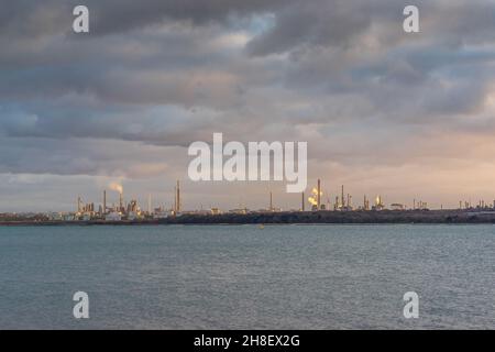 Fawley Ölraffinerie während des Sonnenuntergangs von Netley, Southampton, Hampshire, England, Großbritannien aus gesehen Stockfoto