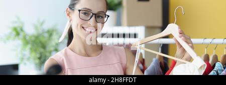 Junge Frau zeigt weißes Kleid vor der Kamera Stockfoto