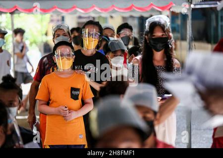 30. November 2021: Patienten warten an einer Schule, um AstraZeneca COVID-19-Impfstoffe zu erhalten, die in eine Impfstelle in Quezon City, Metro Manila, Philippinen umgewandelt wurden. 30. November 2021. Die Philippinen starteten am 29. November eine landesweite dreitägige Impffahrt inmitten der Bedrohung durch Omicron, eine stark mutierte Coronavirus-Variante. (Bild: © Basilio Sepe/ZUMA Press Wire) Stockfoto