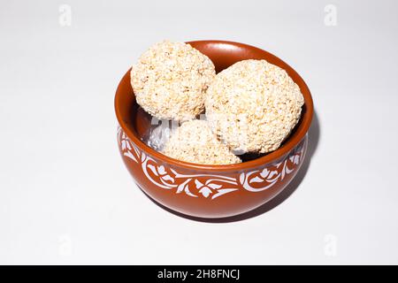 Indische Süßigkeit für traditionelles Festival makar sankranti :Rajgira laddu aus Amaranth Samen in Schale auf weißem Hintergrund Stockfoto