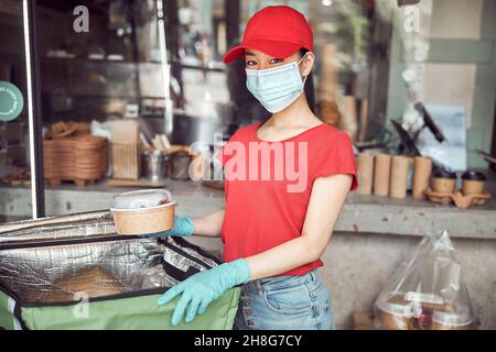 Delivery Frau Ordnung in den Rucksack drinnen Stockfoto