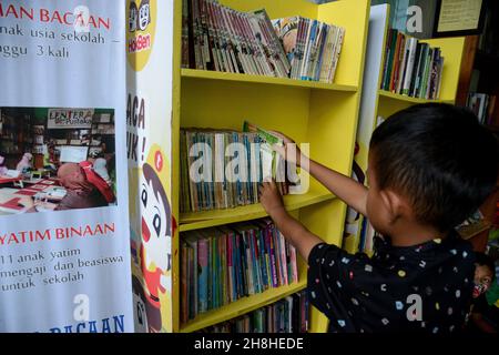 Bogor, Indonesien. 29th. November 2021. Am 29. November 2021 halten Kinder ein Buch in einer Gemeinschaftsbibliothek am Fuße des Mount Salak, Dorf Sukaluyu in Bogor, West-Java, Indonesien. (Foto von Adriana Adie/INA Photo Agency/Sipa USA) Quelle: SIPA USA/Alamy Live News Stockfoto