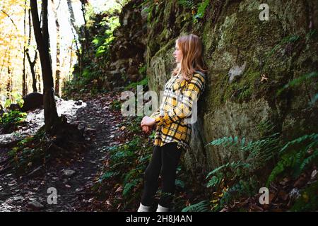 Rothaarige Tween Girl Wandern in den Herbstwäldern. Stockfoto