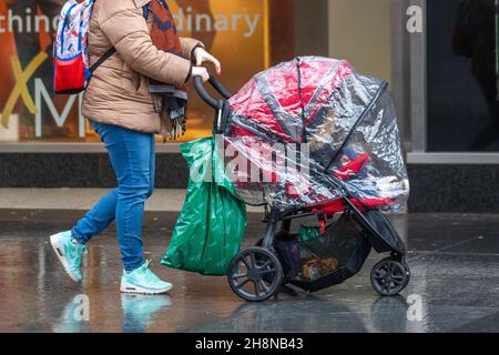 Southport, Lancashire. UK Wetter 01 Dez 2021. Weihnachtsgeschäfte, Einkäufer, die an einem nassen und windigen Tag im Stadtzentrum einkaufen. Der Regen von heute Morgen wird nach Süden ablöschen, aber frische bis mäßige Nordwinde werden anhalten und einen beträchtlichen Kühlfaktor hinzufügen. Credit MediaWorldImages/AlamyLiveNews Stockfoto