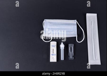 Corona-Selbsttest mit einem Atemschutzgerät auf schwarzem Hintergrund Stockfoto