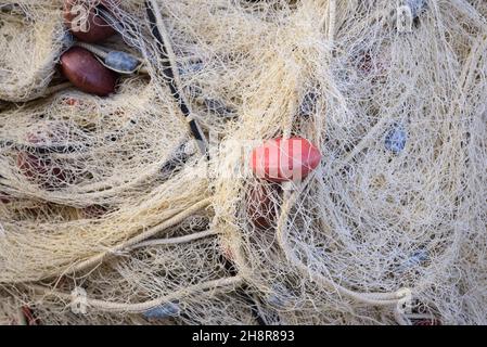 Nahaufnahme, Nahaufnahme und Hintergrund von gebrauchten braunen Fischernetzen, die übereinander gelegt wurden Stockfoto