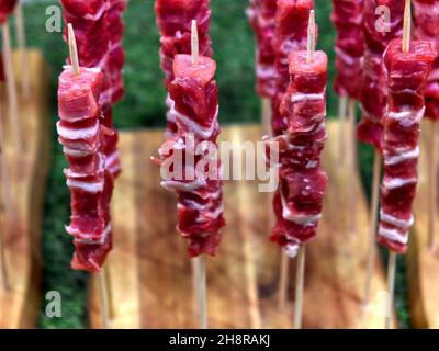 Holzbrett mit der traditionellen -arrosticini abbruzzesi-: Spieße von Schafsfleisch Stockfoto