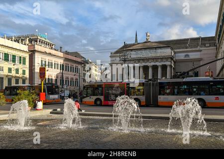 Busse fahren auf der Piazza De Ferrari vor dem Carlo Felice Theater mit den Wasserspielen des Brunnens im Vordergrund, Genua, Ligurien Stockfoto