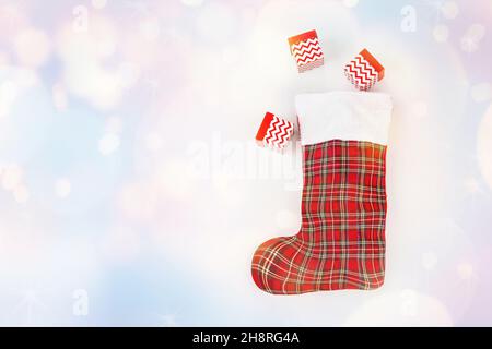 Weihnachtsmann Weihnachtsstiefel mit Neujahrsgeschenken auf einem hellen Hintergrund.Geschenke fliegen aus Santa's Boot.Grußkarte, Banner, Poster.Copy space.Christmas Stockfoto