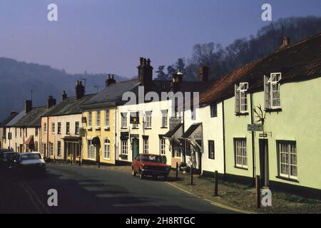 APR 1987: Gebäude, die die Hauptstraße säumen, am frühen Morgen in Dunster, Somerset, England gesehen Stockfoto