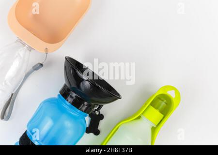 Set von Flaschen für Hunde, um Wasser draußen auf weißem Hintergrund zu trinken. Bunte Flaschen aus Kunststoff mit verschiedenen Formen zum Trinken. Hundepflege Stockfoto