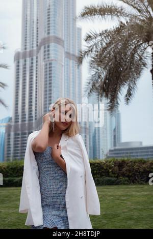 Junge schöne blonde Frau genießt Spaziergang in der Innenstadt von Dubai. Genießen Sie Reisen in Vereinigte Arabische Emirate. Urlaubs- und Sightseeing-Konzept Stockfoto