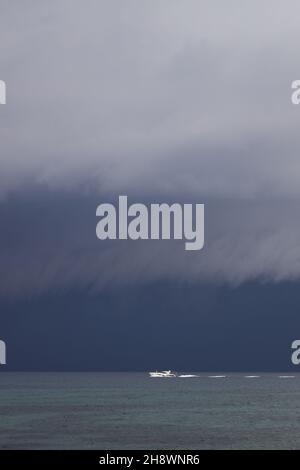 Segeln in den kommenden Sturm. Segelboot bei schlechtem Wetter segeln Meer eröffnet. Segelyacht unter schweren Wolken Himmel. Stockfoto