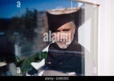 Voller Körper von stilvollen barfuß weibliche Reisende stehend mit Augen allein inmitten von einsamem Gelände mit vulkanischen Steinen unter blau bewölktem Himmel, während Stockfoto