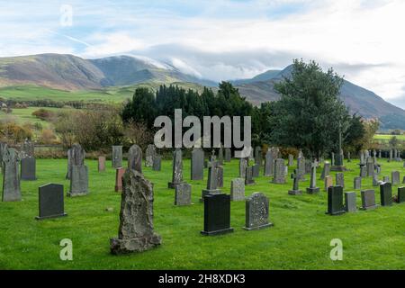 Ländlicher Kirchhof in der St. Johns Church, Bassenthwaite im Lake District National Park, Cumbria, England, Großbritannien, mit Hügeln im Hintergrund Stockfoto