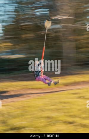 RAJHRAD, TSCHECHISCHE REPUBLIK - 22. Okt 2021: Eine lange Exposition eines kleinen Mädchens, das Spaß auf dem Swing hat Stockfoto