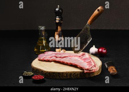 Rohe, frische Lammrippen, ungeschnitten mit Gewürzen und Kräutern Stockfoto