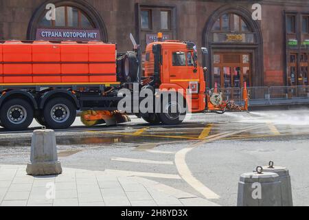 Städtische Bewässerungsmaschine wäscht und sprüht Wasser auf Asphalt der Straßen im Stadtzentrum von Moskau .Stadtwerke Stockfoto