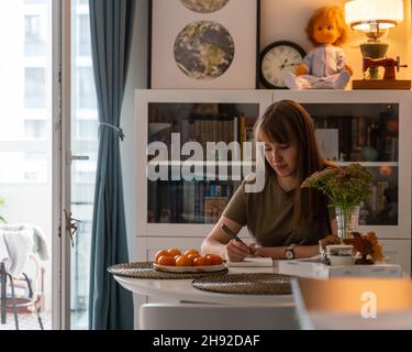 Writing thoughts in notebook. In anticipation of new year. Making list. Cozy atmosphere Stockfoto