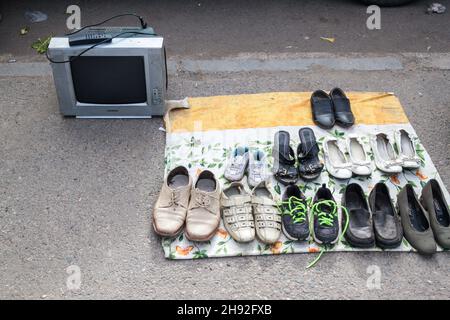 BISCHKEK, KIRGISISTAN - 19. MAI 2017: Schuhe und Fernsehen zum Verkauf in der Nähe des Osch-Basars in Bischkek, der Hauptstadt Kirgisistans. Stockfoto